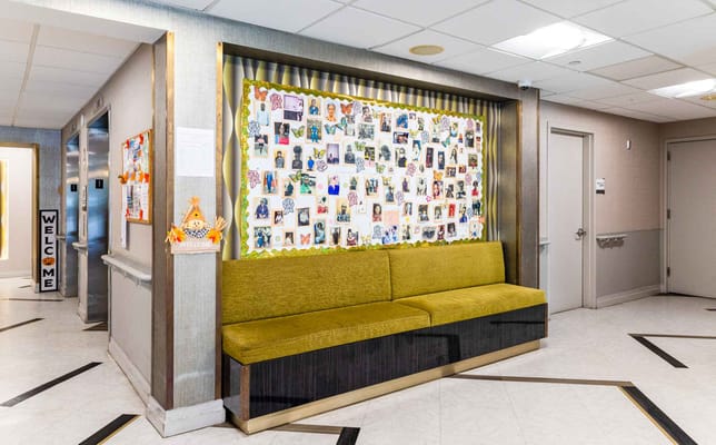 Hallway seating area with photo collage on the wall