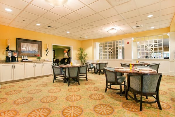 Dining area with tables and chairs in a bright room