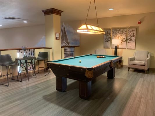 A pool table in a common area of the facility