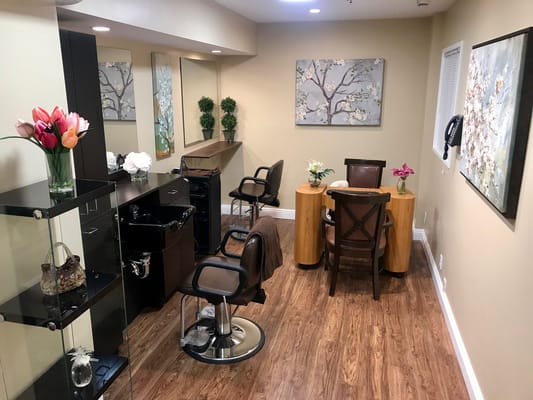 Well-lit beauty salon area with styling chairs
