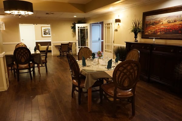 Dining area with tables and chairs set for a meal
