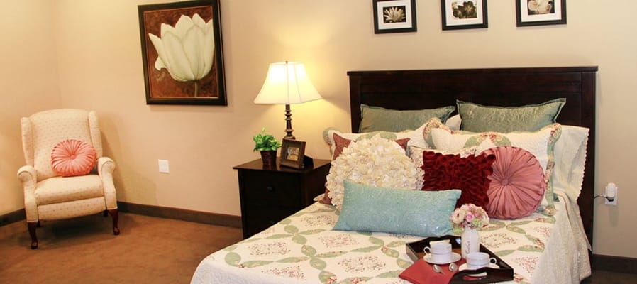 Cozy resident room with floral decor and comfortable bedding