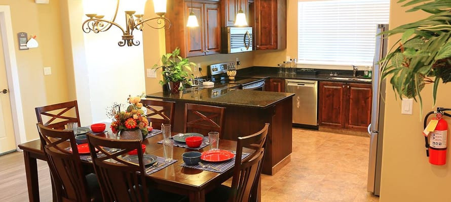 Cozy dining area with a set table and kitchen