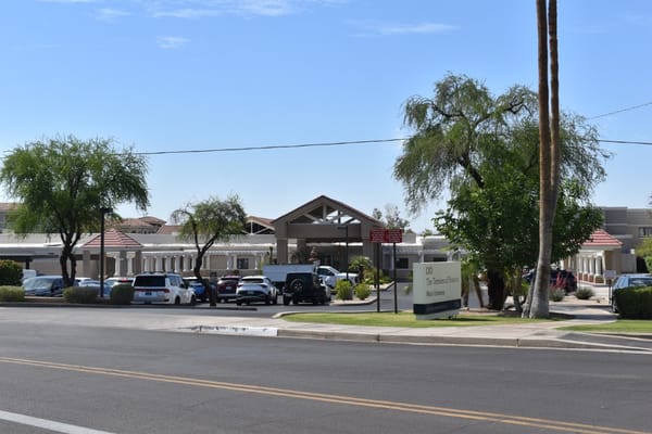 Main entrance view of The Terraces of Phoenix with parking area.