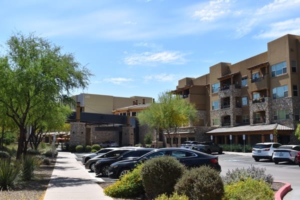 Exterior view of Sagewood senior living facility with parking area
