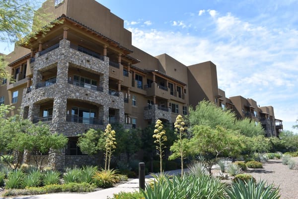 Exterior view of Sagewood senior living facility with stone and balcony features.