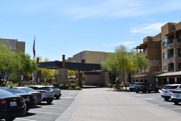 Main entrance area of Sagewood with parked cars and landscaped surroundings