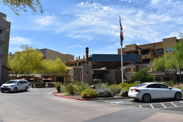 Outdoor view of Sagewood senior living facility with flagpole.