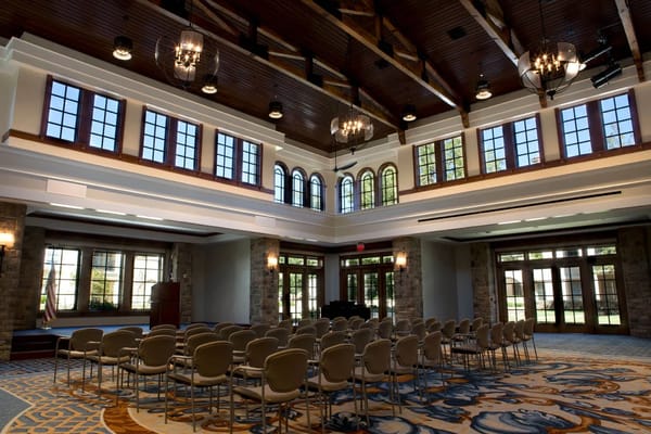 Spacious event room with chairs and large windows at Edgemere