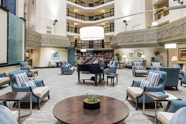 Spacious and elegant lobby with a grand piano and seating area