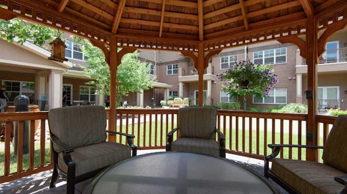 Cozy gazebo with seating and view of gardens