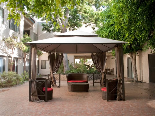 Outdoor seating area with gazebo and chairs