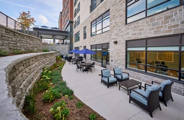 Outdoor seating area with plants and umbrellas