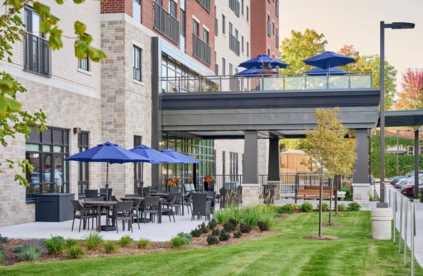 Outdoor seating area with umbrellas and landscaping
