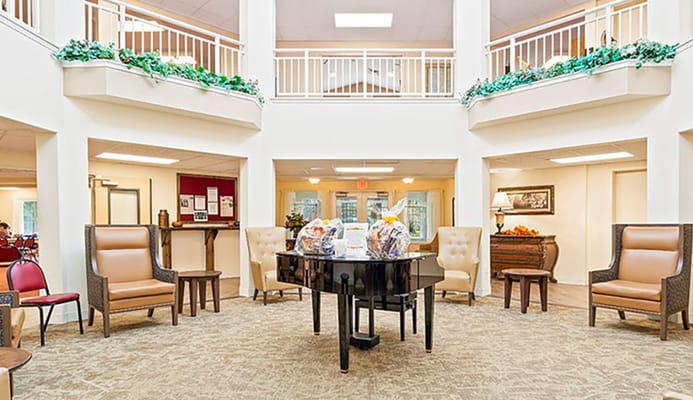 Spacious lobby with a grand piano and seating areas