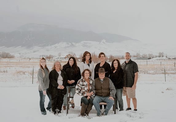 Group of staff members posing in snowy outdoor setting