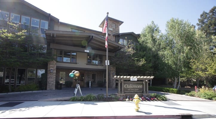 Exterior view of Oakmont of San Jose with entrance and landscaping.