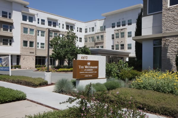Entrance sign of The Watermark at Almaden with landscaped area.