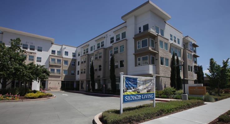 Exterior view of The Watermark at Almaden with a senior living sign