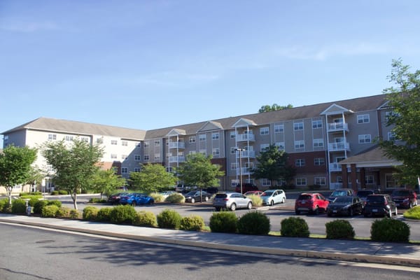 View of The Crossings at Bon Air senior living facility with parking area.
