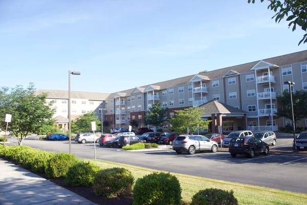Exterior view of The Crossings at Bon Air, featuring the building and parking area.