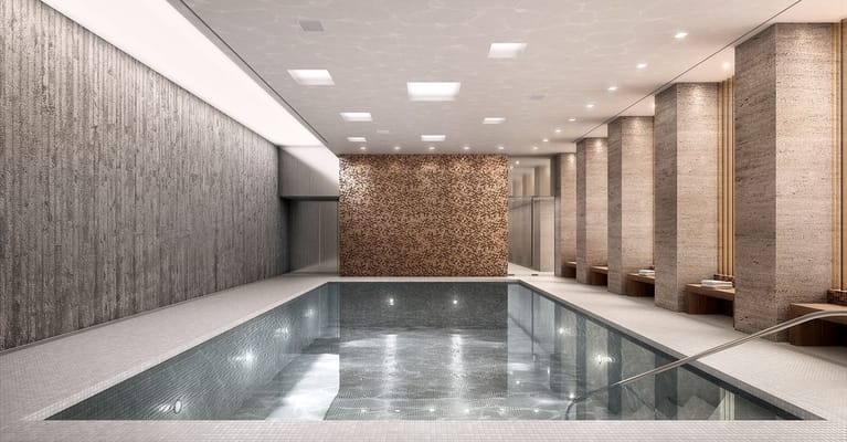Modern indoor swimming pool with tile flooring and lounge space