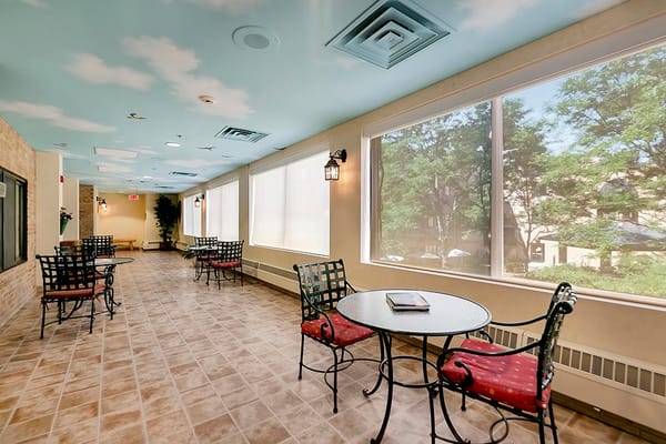 Bright common area with seating and large windows