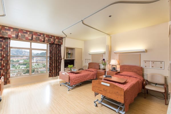 Bright interior view of a resident room with two beds