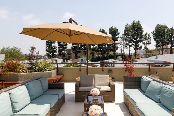 Outdoor lounge area with seating and an umbrella