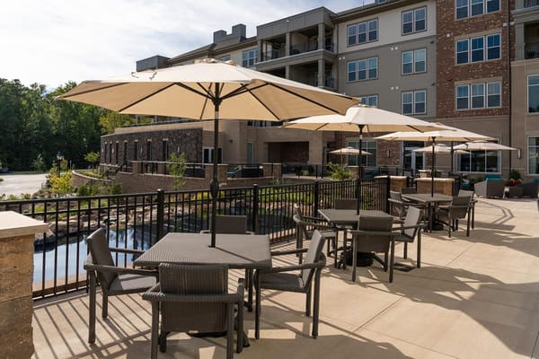 Outdoor seating area with umbrellas at Lakewood Retirement