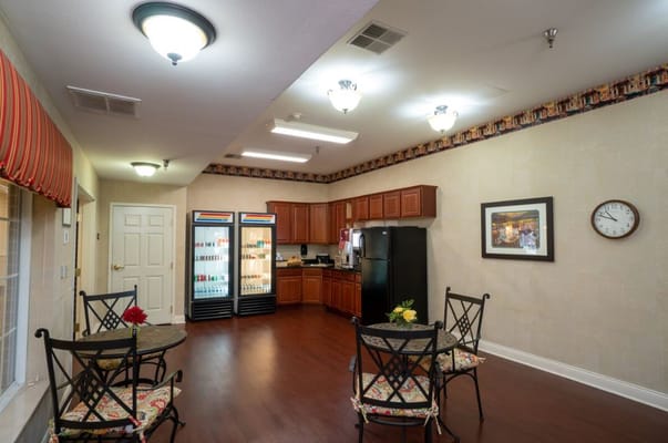 Bright common area with seating and kitchenette