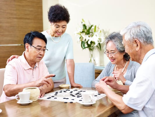 Residents enjoying a game together in a common area
