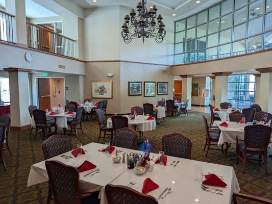 Interior view of a dining room with tables set for a meal