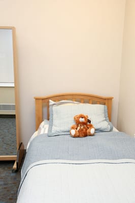 Cozy resident room with a bed and a stuffed animal