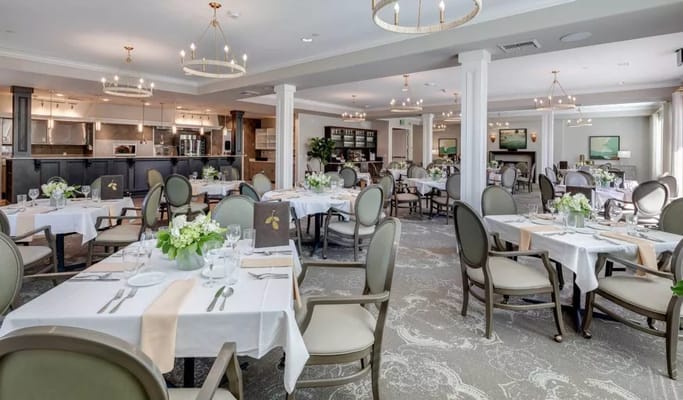 Bright dining room with tables set for meals