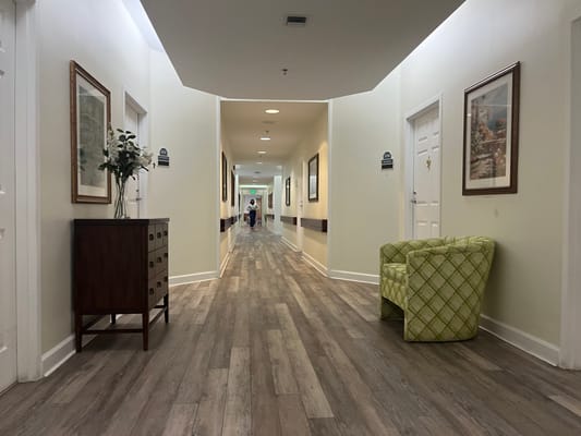 A hallway in the assisted living facility with a green chair