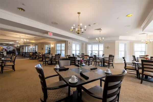 Bright and inviting dining room with tables set for meals