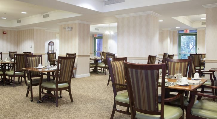 Dining area with tables and chairs set for meals