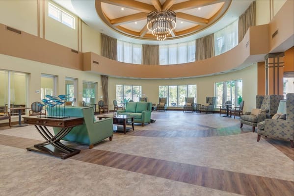 Spacious lobby with green seating and decorative accessories