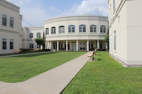 A scenic view of a courtyard with benches and pathways