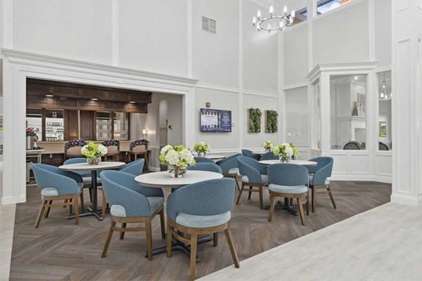 Bright dining room with tables and flowers
