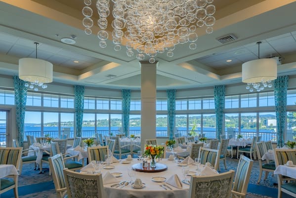 Elegant dining room with large windows and a view of the waterfront