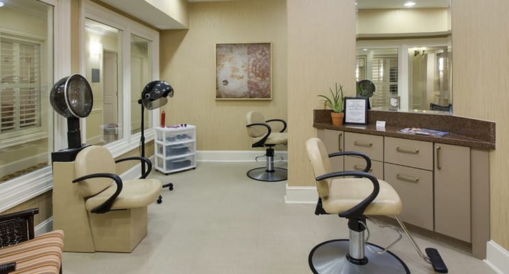 Interior of the hair salon featuring styling chairs and hair dryers.