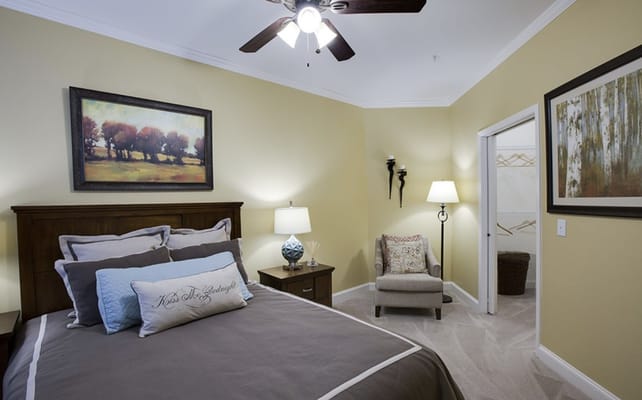 Stylish bedroom with a bed, artwork, and seating area