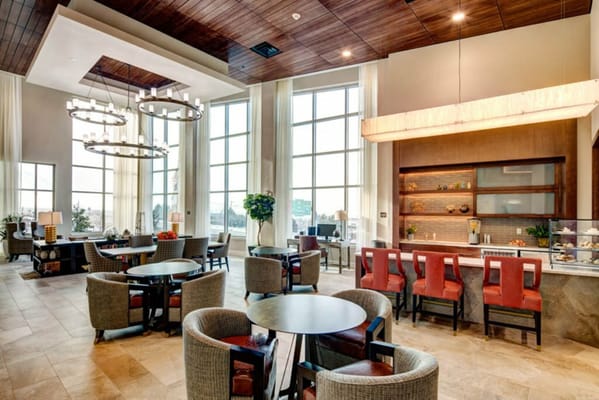 Spacious lounge area with seating and large windows