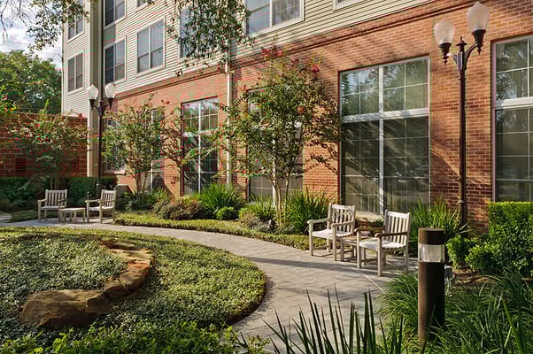 Scenic garden pathway with seating at The Vosswood Nursing Center.