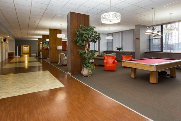 Bright common area with seating and a pool table
