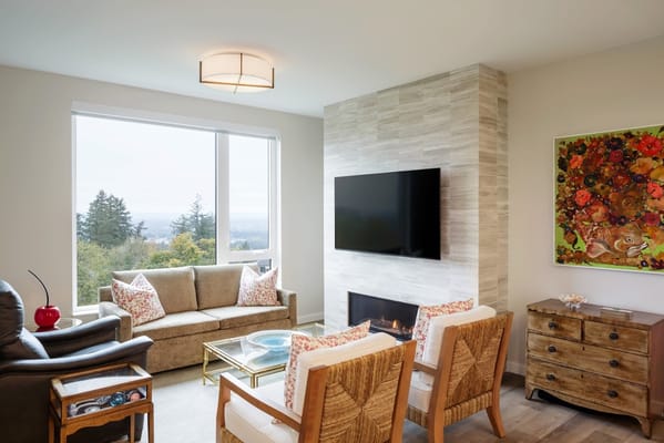 Comfortable living room with a view, featuring a sofa, armchairs, and a television.