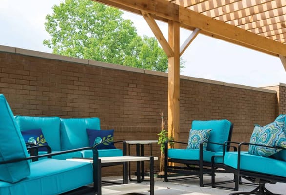 Outdoor seating area with turquoise chairs and cushions