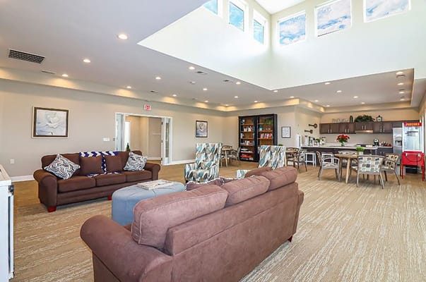 Bright common area with seating and kitchenette